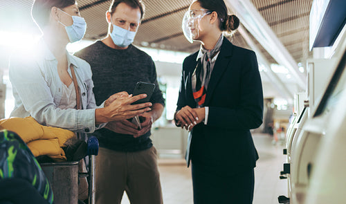 Tourist family taking help of airport staff