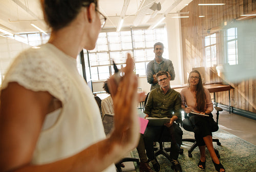 Female executive discussing ideas with colleagues