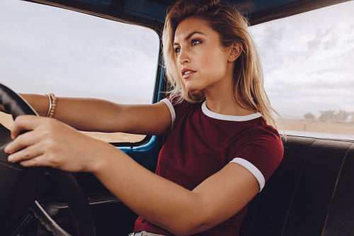 Woman driving a car on road trip