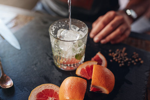 Bartender preparing cocktail.