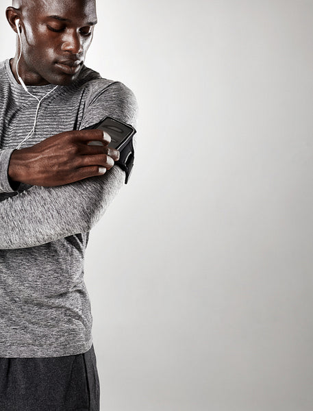 Young black male model listening to music on cell phone