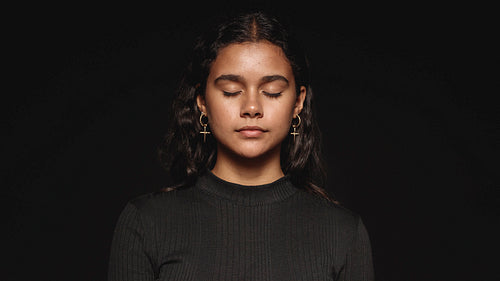 Young woman with eyes closed