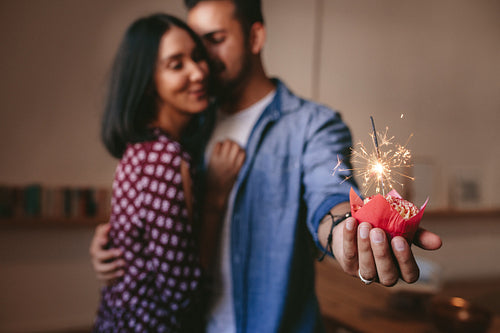 Romantic couple celebrating their anniversary with cup cake
