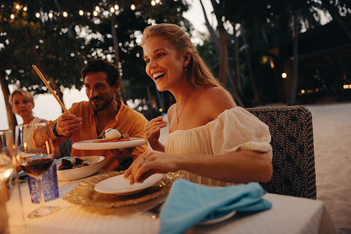 Family enjoying luxury outdoor dining at a seaside resort