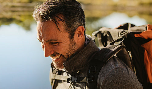 Camper smiling by the lake