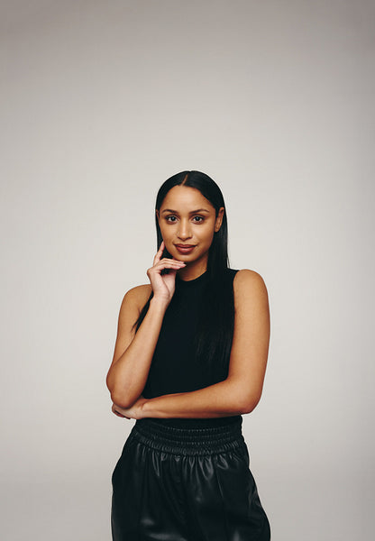 Fashionable young woman standing in a studio
