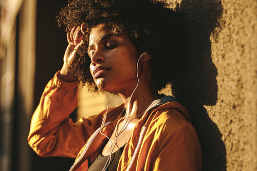 Sporty woman relaxing after exercising