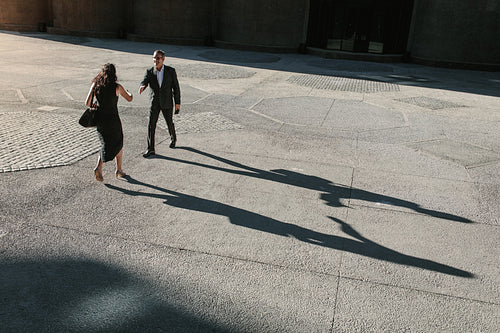 Aerial view of business colleagues meeting each other on a street while commuting to office