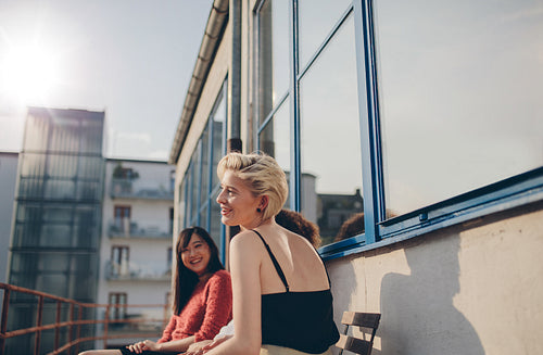 Three young women sitting in balcony