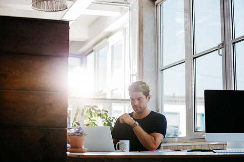 Young businessman working in modern workplace