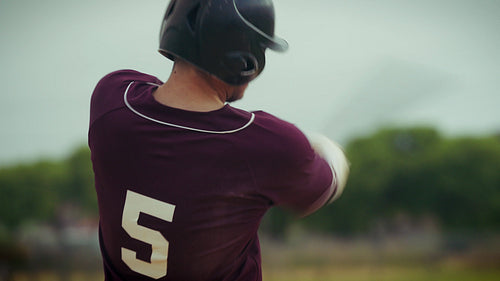 Baseball player runs after hitting a pitch