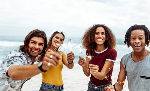 Diverse group of friends celebrating new year's at the beach