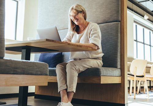 Positive mature businesswoman smiling during a video call
