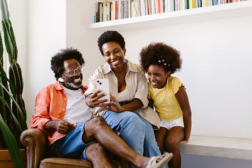 Happy family enjoying video call on a smartphone at home