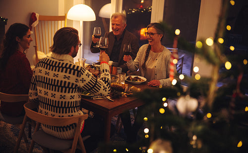 Family enjoying Christmas dinner with drinks 