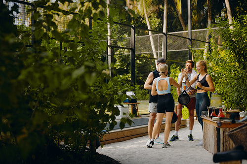Family standing outside a padel court at a luxury resort