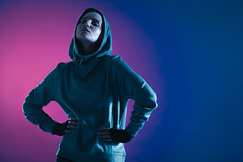 Sportswoman in hooded sweatshirt
