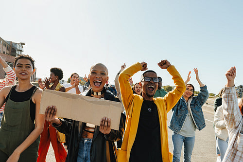 Young diverse adults protesting outdoors for unity and positive social change