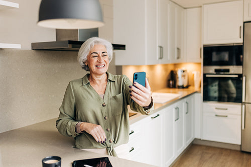 Smiling senior woman taking a video call on her smartphone