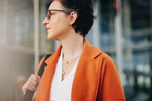 Business woman looking away while walking to work in the city