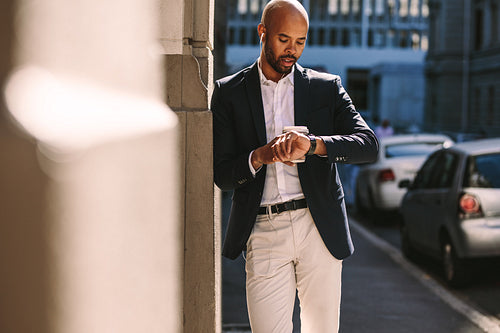 Young businessman checking time