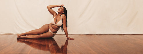 Woman sitting comfortably on a studio floor