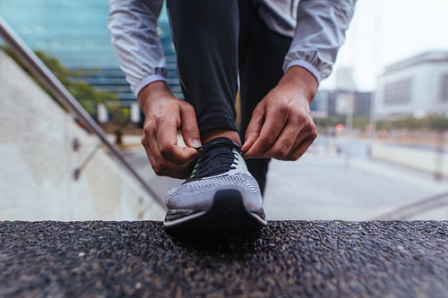 Close up of a man tying shoe lace