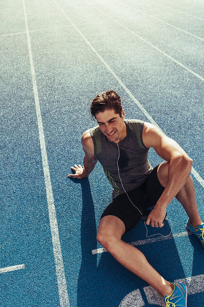 Sprinter relaxing on running track