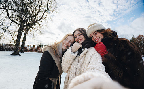 Women take a happy winter selfie together outdoors