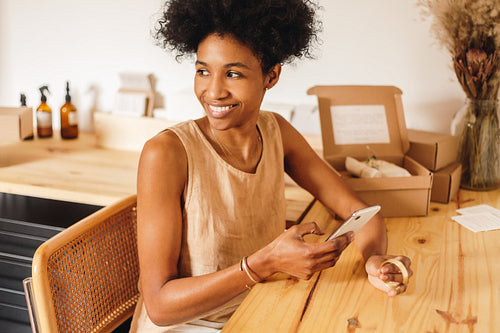 Jewelry designer taking photos of ornaments in office