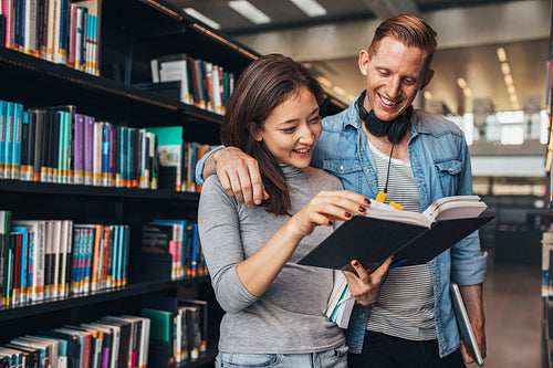 Couple of young students at public library