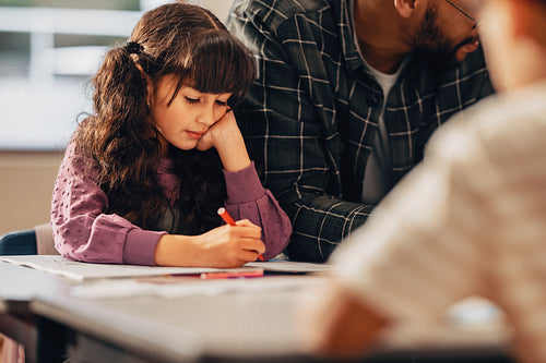 Child pays attention to her school work in class