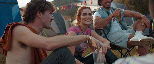 Group of friends enjoying a music festival campsite together