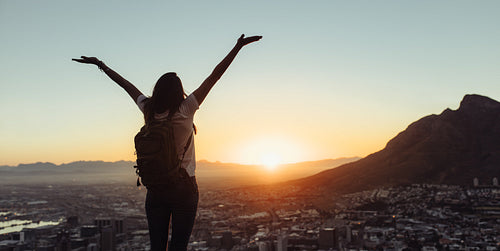 Woman hiker admiring the sunset view