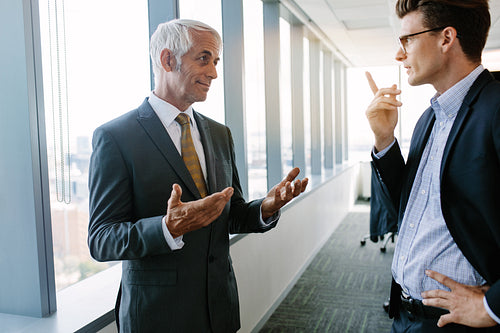 Senior manager discussing with a colleague