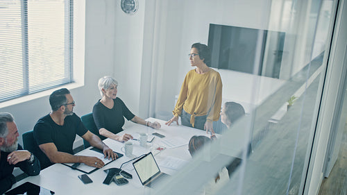 Team appreciating the efforts of a colleague in a meeting