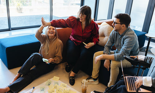 Young professionals brainstorming ideas together in a creative modern office space