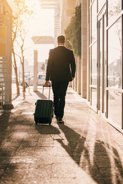 Business traveler with suitcase outside airport