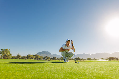 Golfer aiming to make his next putt perfect.