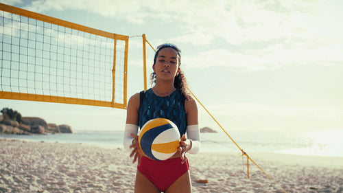 Professional female beach volleyball player smiling at the camera
