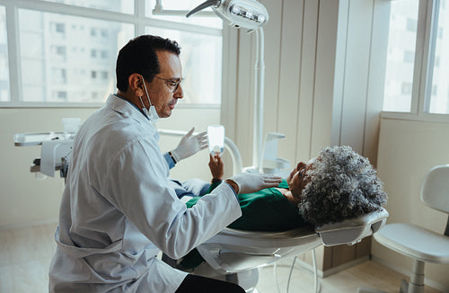 Exam brings dentist and senior patient together in calm clinic setting