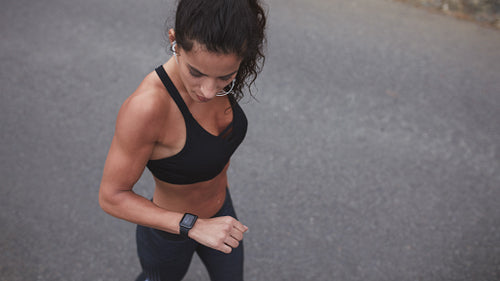 Female athlete checking her smart watch after a run