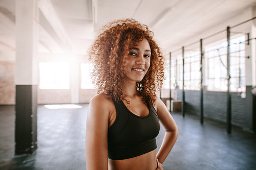 Smiling young fitness model in health club