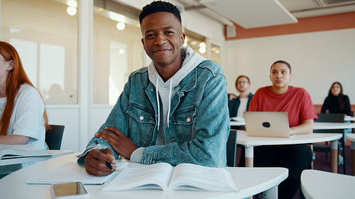 Happy student in university lecture hall