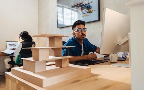 Young professional architects working on design projects in a modern studio environment