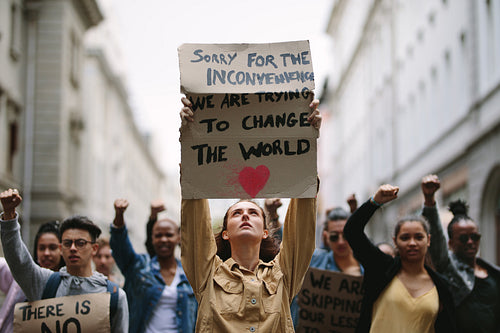 Large group of demonstrators march up the street