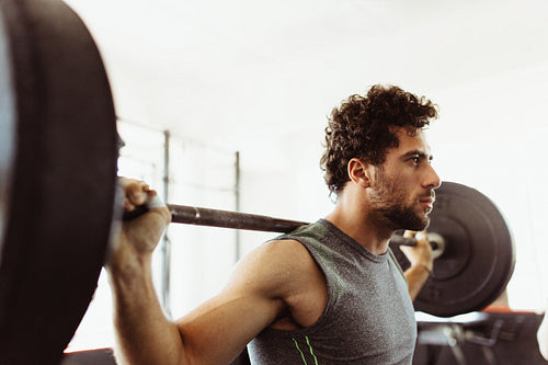 Bodybuilder working out with heavy weights