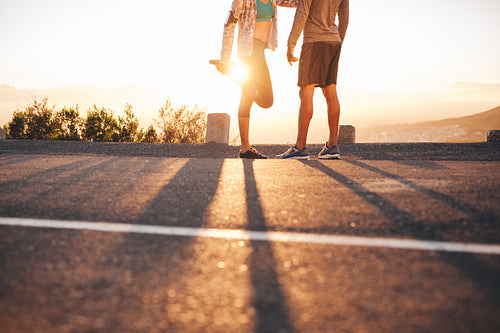 Fit young couple warming up before a run