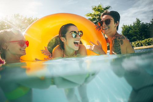 Women friends having fun together in pool