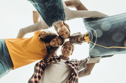 Friends standing in a huddle